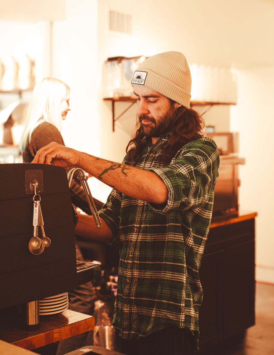 Barista pulling espresso, coffee shop brand content
