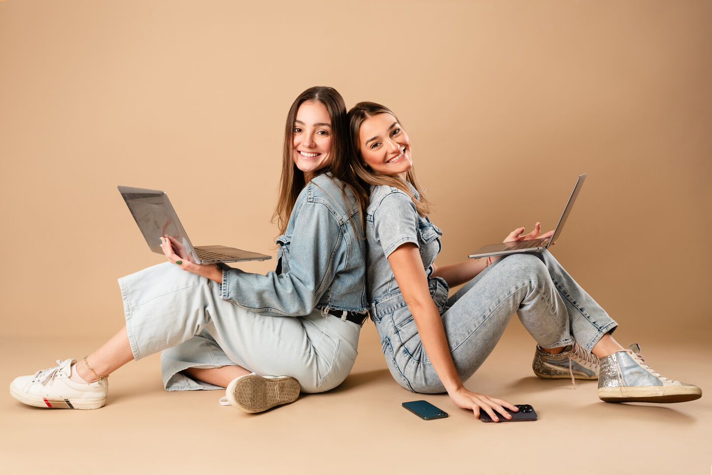 Two Studio T Creative team members with laptops