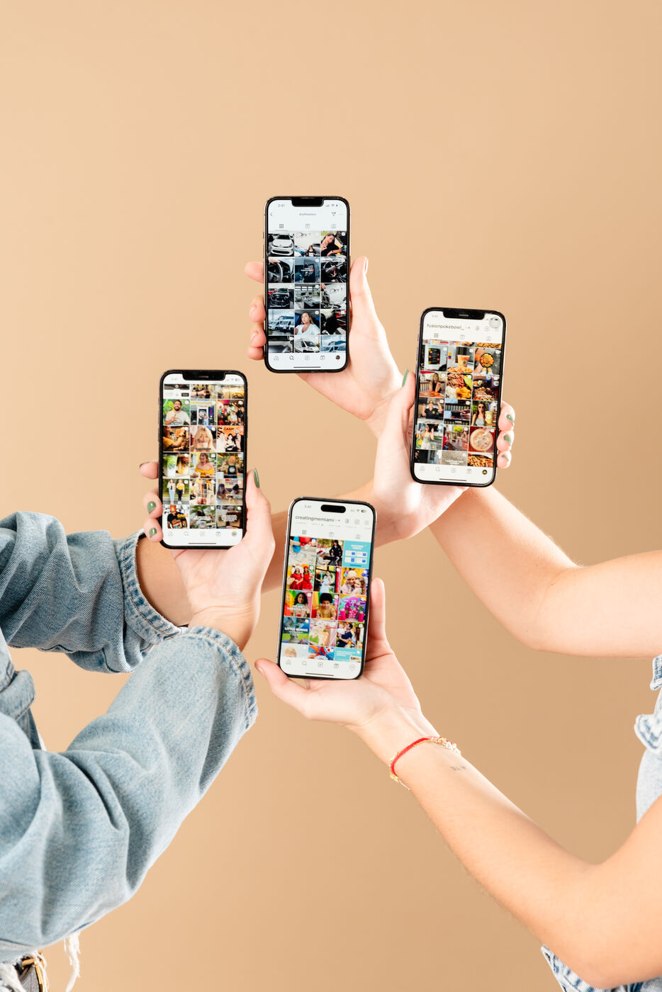 Hands holding phones showing branded social content